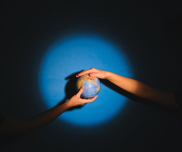 Abstract representation of connected people, glowing with cyan light.